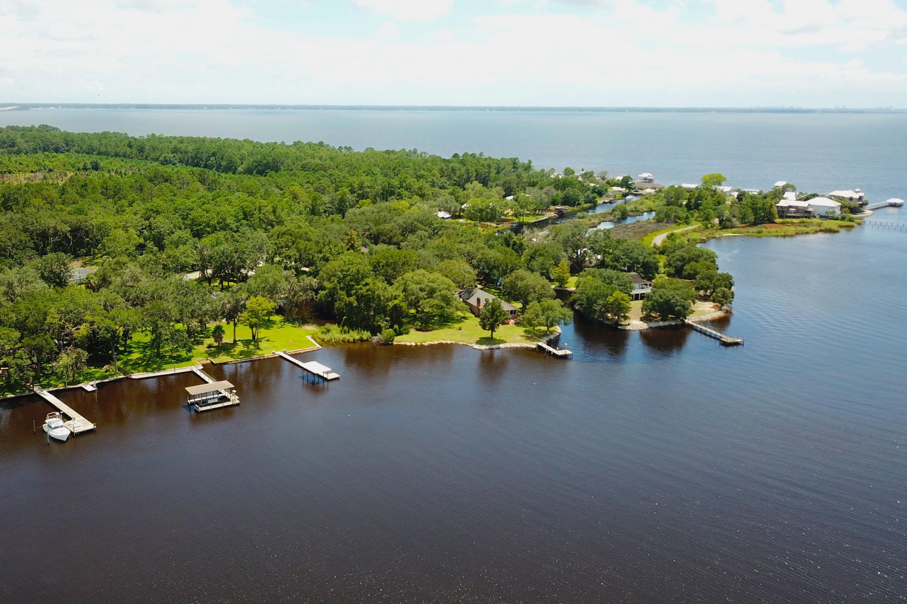 This outstanding waterfront lot in Freeport offers bayfront living with approximately 94 feet of prime water frontage on LaGrange Bayou. Covering almost three quarters of an acre, it offers privacy and seclusion with open views and direct access to Choctawhatchee Bay and the Gulf of Mexico beyond. There is an existing dock and boathouse with a boat lift. The lot is a prime site for building a dream home tucked away beneath shady mature oak trees. Despite its unspoiled location, the lot is conveniently close to shops, schools, restaurants and amenities, just 10 minutes away.