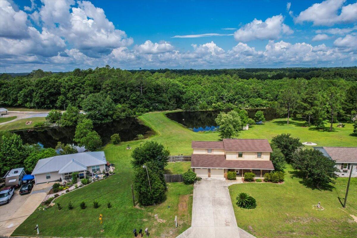 NO HOA!!! Shared Access to Private Pond. Immerse yourself in the tranquil beauty of a backyard oasis with a serene pond and breathtaking evening vistas. Step into the embrace of this delightful 4-bedroom, 2.5-bathroom residence, spanning 2132 sq ft over two levels. The expansive design features a cozy living area and a screened back porch, ideal for unwinding amidst nature. Upstairs, the primary suite offers a secluded sanctuary. Positioned for convenience, this home harmoniously combines peace and convenience. Embrace the opportunity to make this captivating property yours - schedule your showing today!Water Heater (2024)HVAC (2021)Roof (2018)