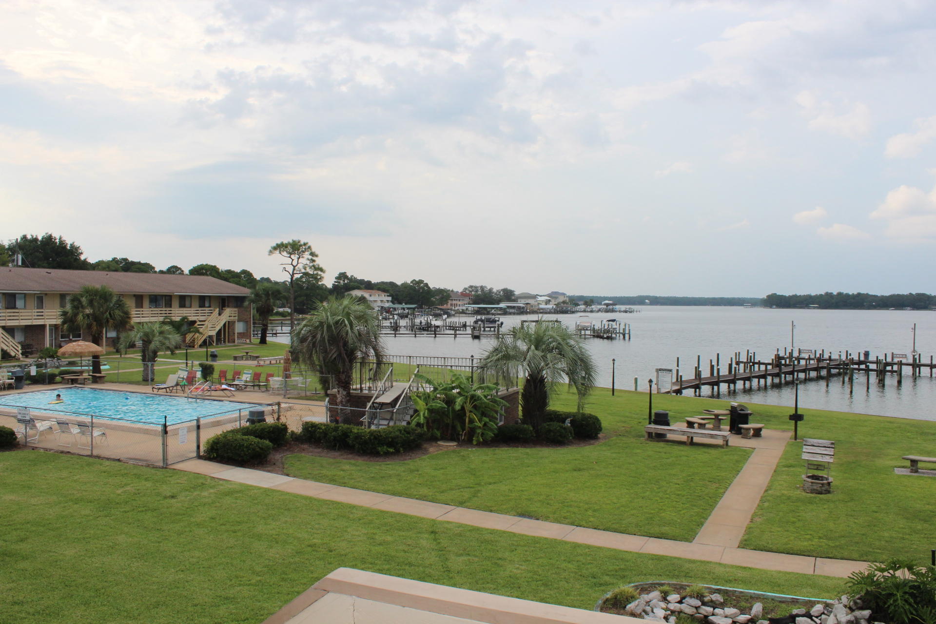 Beautiful unit with views of Garniers Bayou. This is affordable waterfront living in convenient central FWB location. Near Shalimar and Hurlburt & Eglin AFB. Just out the door you are steps to waterfront pool, dock with 21' boat slips, two grilling picnic areas and a large grass area for pets all nestled on the bayou. Unit is in great condition, clean and has some furnishings included. All and newly Tiled throughout. Large living area floods with afternoon light. New windows in 2014. Two entrances w/storm doors. Hurricane pegs installed with plywood. Ceiling fans in BRs and living area. Quiet & serene. Bring your boat and enjoy waterfront living for less. Call Today!