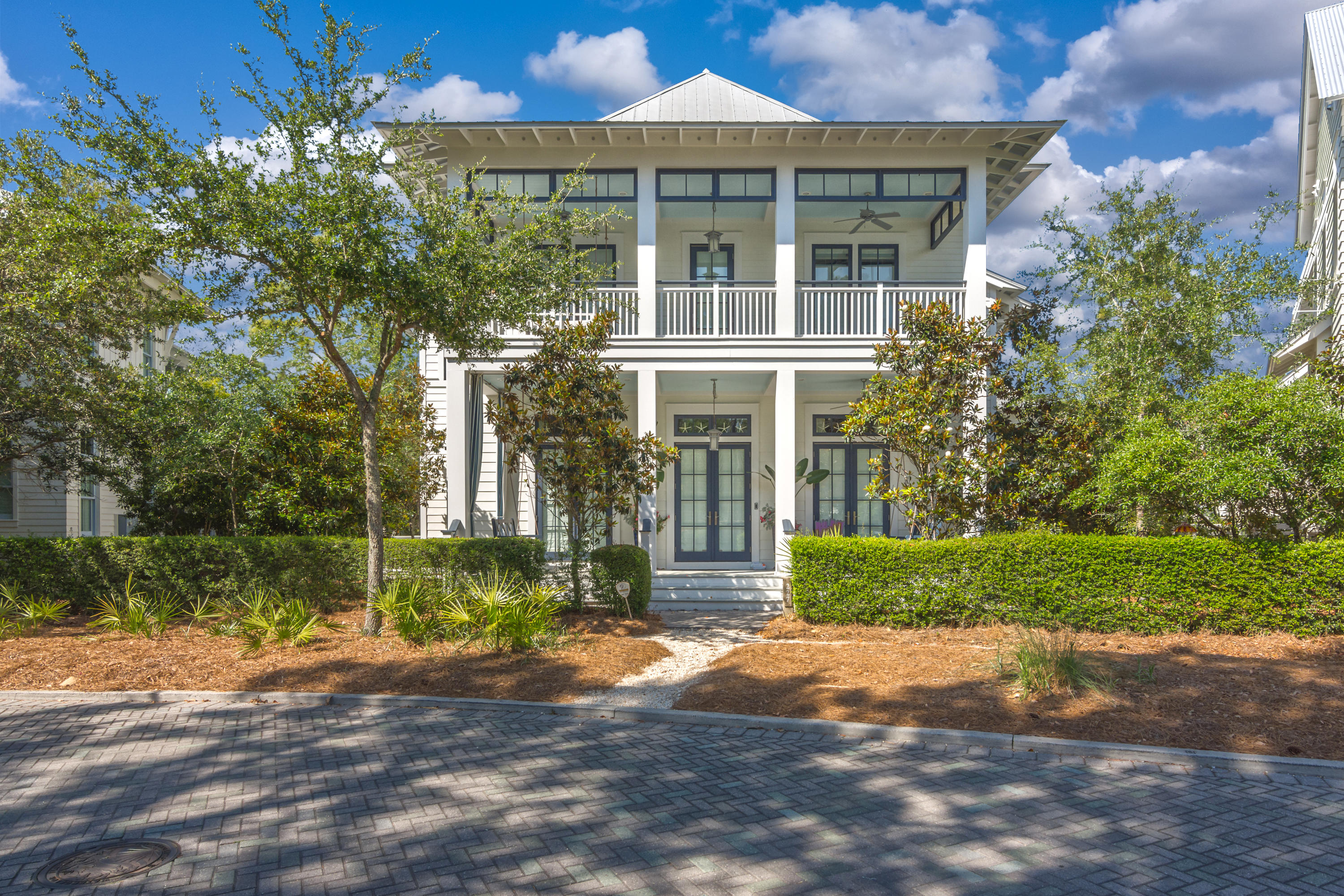 This custom beach house, carriage house and 2 car garage is located in highly desirable Watercolor Phase 3, steps away from the frog pool and a short walk to the newly expanded Beach Club and Camp Watercolor. Sold FULLY FURNISHED with a small list of exclusions. The wallpaper on the lower level and stairs will be removed and painted white. With immaculate attention to detail and special touches throughout, this home has never been rented. Exquisite oak floors, an elevator, 3 sets of french doors, custom marble floors and counters, floor to ceiling drapes with tailor-made blinds, and elegant crown molding give this home a stately and refined appeal. The well equipped kitchen features an expansive center island, a breakfast bar, a Wolf oven, cook top, warming drawer, and microwave,