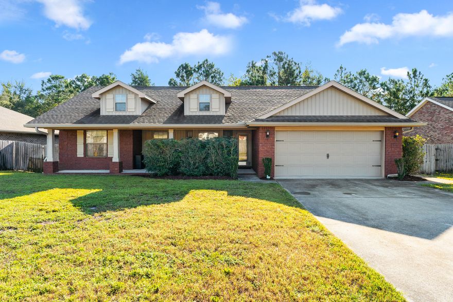 DON'T MISS THIS BEAUTIFUL HOME IN NAVARRE! Just past the covered porch, step inside and discover all this home has to offer.  The kitchen offers stainless steel appliances and breakfast bar. The living area is framed by three large windows that bring in an abundance of natural light with views of the tree line. The master bedroom has trey ceilings with ceiling fan and a private ensuite. The primary bathroom features a double vanity, separate shower and soaking tub. The two additional bedrooms and bathroom offer an abundance of space for the family. Spend your days inside enjoying your home or outside soaking up the sun on the open deck. This property backs onto Tom King Bayou, giving added privacy in the fenced backyard. Schedule your showing today and let us welcome you home!