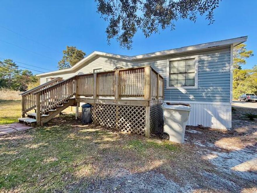 Great first home, last home, vacation home or investment property...so many options! Water right down the street! Split bedroom floor plan for ultimate privacy. Nice size living area w/ cathedral ceiling. Eat in kitchen w/ all appliances in place, pantry, center island, etc. Inside laundry room w/ utility sink. LVP & tile flooring throughout. All electric! Newer decking on front & back great for relaxing/entertaining! Seller says approx. 2022 Re-plumb 2011 Vinyl Siding 2012 HVAC 2007 WH 2005 Roof. Seller replacing water heater & will replace the roof w/ a full price offer or give an allowance for buyer to do so after closing. Welcome home!