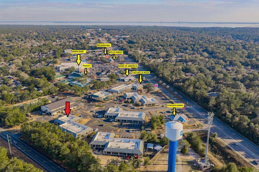 Prime CLASS A LARGE, OFFICE SPACE in Merchant's Walk, one of the busiest & most popular commercial complexes in Bluewater Bay.  Offering 3 strategically placed entrances: 1 in the front & 2 in the back, this 3000 SF commercial space offers opportunity for one large business or the subdivision & accommodation of several businesses.  Current configuration includes both front & back reception areas each with their own entrance, an open, giant work space flooded with natural light, large meeting room, spacious break/kitchen area w/exterior entrance, 8 offices and 2 bathrooms.  This property's coveted corner location with floor to ceiling windows throughout the space provide lots of natural light & inviting work environment. Ample space for signage & plenty of parking complete the picture.