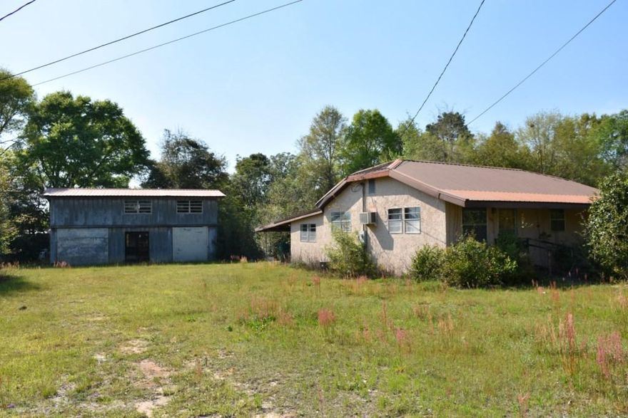 Handyman Special! This home has a lot of potential...large 100x150 lot & 2-story detached shop/barn. Stucco home with a metal roof. The master bedroom has 2 closets and the smaller bedroom has a closet plus a step down to an add-on walk-in closet. Selling AS''IS. No warranties by seller. Seller Disclosure not available. MOLD is present & some floors slippery. Zoned for single or multi family with MDR Future Land Use (Medium Density Residential)