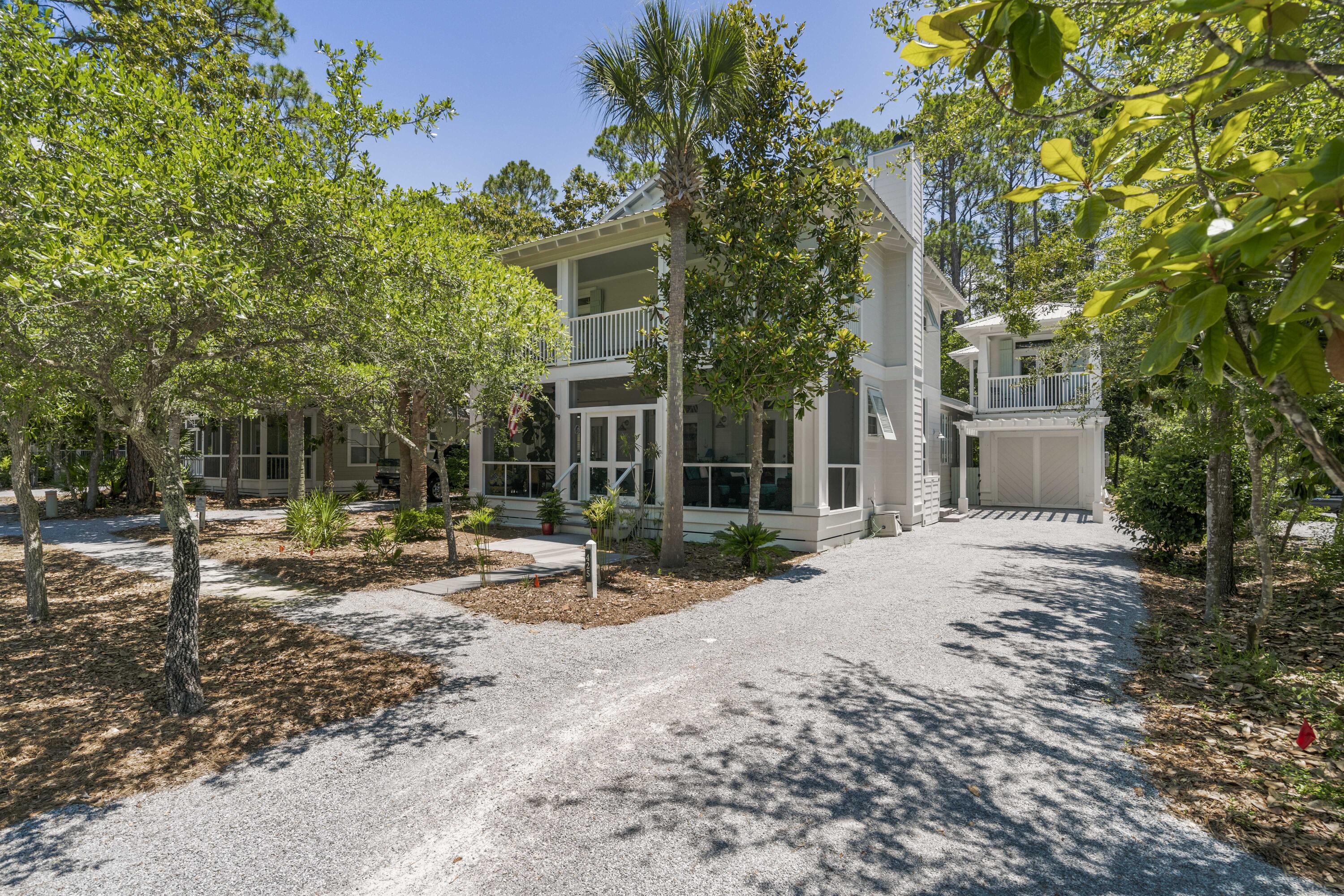 This hidden gem is nestled in the front of Grove by the Sea, creating the best opportunity to access one of the two community pools, while also being a short walk to the beach or a bike ride to Seaside. The main house features 4 bedrooms & 3.5 bathrooms with a 1st floor Primary Suite. The Carriage House has a bedroom & bath on the 2nd level with an office & storage room below. Recent renovations to the first floor turned your beach home into your dream home. The spacious living room & dining area flows directly into the gourmet kitchen with high end appliances & a custom-built wine cellar. Enjoy the property's outdoor spaces, the large screened front porch; open balcony above that is accessed from two of the guest rooms; or take in the back deck perfect for grilling or a dip in the hot tub