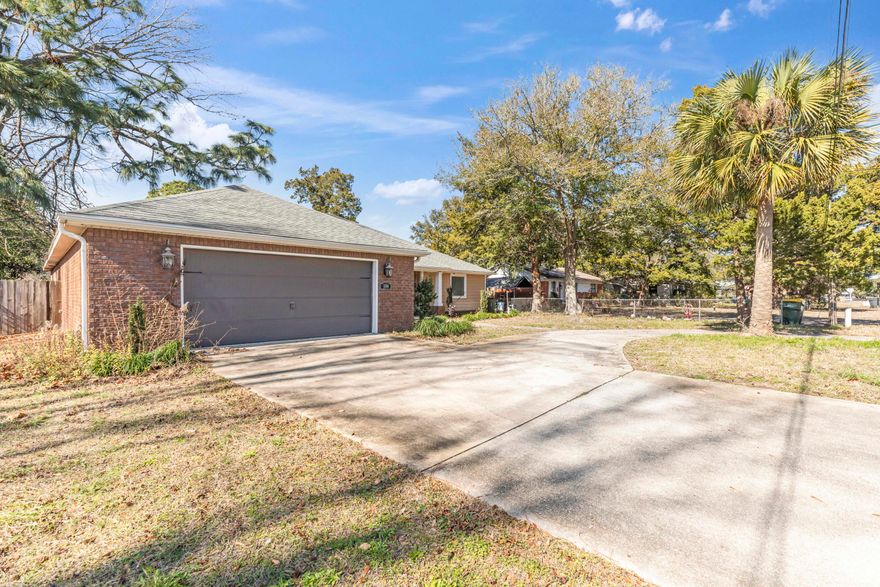 Ready for immediate occupancy! Conveniently located within blocks to shopping dining and work. This property is 5 miles from Hurlburt AFB and 8 from Eglin. Plenty of parking space with a semi-circular driveway and oversized 2 car garage. Step inside the home to a well-lit, and open floor plan for dining, living and kitchen spaces. Split floor plans with 2 additional bedrooms on one side of home and primary bedroom on the other. Kitchen has ample cabinet space, granite countertops, and pantry. Down the hall from kitchen is a full laundry room with additional cabinets and utility sink. Step outside and enjoy the large, covered porch that looks over the fully fenced back yard. Pets are welcome with pet fee and approval. All tenants 18+ are subject to credit and background checks.