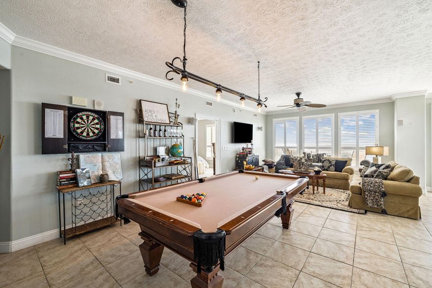 The Captain's Lodge | Top-Tier Themed STR | 17th Floor End Unit. Set sail for high returns at Treasure Island's most unique 3BR/2BA corner suite. 'The Captain's Lodge' isn't just a condo; it's a high-performing, immersive vacation experience. This 1,950 sq. ft. end unit offers wrap-around views of the Gulf and Grand Lagoon from the 17th floor. Themed ROI: Professionally designed with a nautical 'lodge' vibe, including a full-size pool table, vintage darts, and a 'Titanic-inspired' Master Suite. Space to Scale: Sleeps 10+ with a layout designed for multi-family groups. Prime Location: Steps from St. Andrews State Park & Schooners. Fully furnished and rental-ready on day one.Experience a '1 of 1' property in a premier resort with a heated Gulf-front pool, fitness center, and pet-friendly.