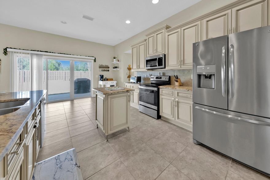 Enter this gorgeous brick home through the double front doors that has been meticulously maintained. The open tiled foyer flows into the spacious family room with the dining room perfectly placed for entertaining. The kitchen is a chefs dream with plentiful granite counter top space, ample cabinet glazed cabinetry and stainless steel appliances. The home has a split floor plan with master bedroom on the left side of the home, boasting double granite vanity, tiled shower, garden tub and a walk-in closet off the bathroom. The master bedroom and one additional bedroom is complete with LVP wood flooring. Two additional bedrooms are carpeted and share a full bathroom on the opposite side of the home provide plenty of privacy for everyone.