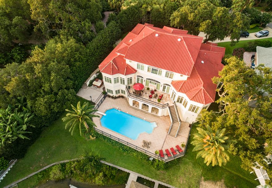 Experience an unparalleled waterfront lifestyle right in the heart of Gulf Breeze Proper. This stunning waterfront home was meticulously designed with casual coastal living and gracious entertaining in mind. Privately tucked in beautiful live oaks and moss draped tree lined drive is a custom built Mediterranean beauty with 7280sf, 6 bedrooms, 5 baths and 2 half baths is situated on 165ft of protected waterfront 18 feet above sea level where you can enjoy a pool that over looks the bayou and bay. The Deepwater slips will accommodate a 60ft yacht and additional boats. Enjoy the coastal elegance the minute you walk through the front door.Its open design was meant for entertaining.
