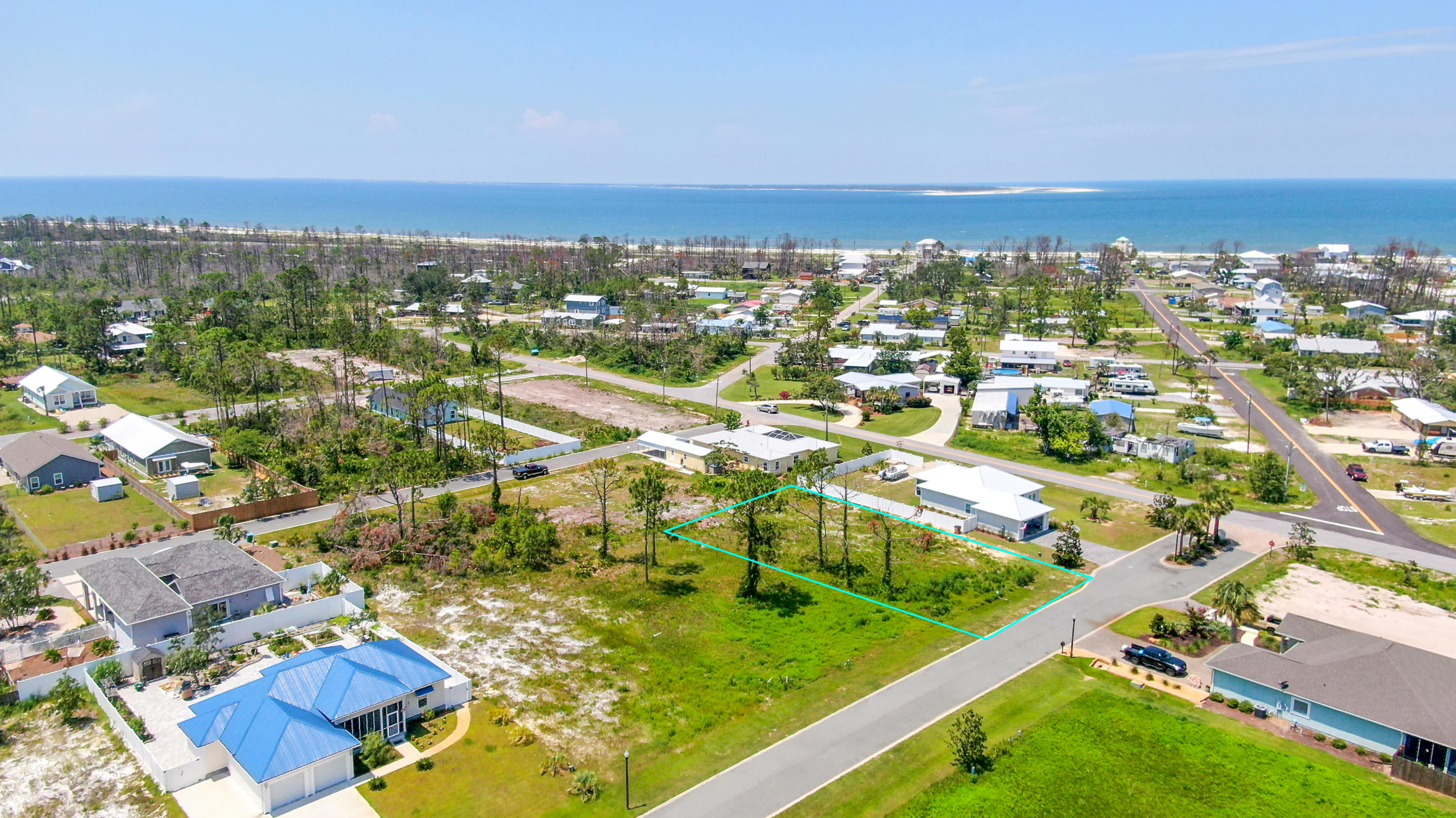Second lot to the right after entering Magnolia Bluff Subdivision, just a few blocks from St. Joe Beach. This is a great neighborhood! This nice, large cleared lot is within 1/2 a mile of the beach. Water, sewer, and gas are available. Tap fees will run around 8,000. Lot is ready for you to build your beach home on! Lot is 77' X 141'. Magnolia Bluff has an annual HOA fee of $290. The minimum square footage to build a one story home is 1,300 heated/cooled sq. ft. Minimum square footage on two or more stories is 800 sq. ft. Detached garages for cars or boats are permitted as long as they are in harmony with the design of the home. No short term rentals allowed in Magnolia Bluff.