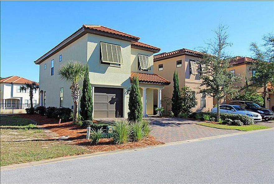 This property truly stands out above the rest with a rejuvenating coastal ambiance, crown molding, granite countertops, new appliances, and beautiful furnishings. From the moment you enter the villa, a wave of peace washes over you as you realize the beach is close by. The living room holds a large wall mounted flat screen T.V..with plush, comfy furniture and sleeper sofa. The kitchen boasts beautiful white cabinetry with a breakfast bar that looks over the living room and T.V.. A large dining table offers seating for eight and overlooks the canals of Villa Lago. A powder room is also located on the first floor for convenience. The back patio with outdoor furniture, propane grill, and outdoor fan allows you to get the most out of the warm Florida weather.Upstairs holds three bedrooms.