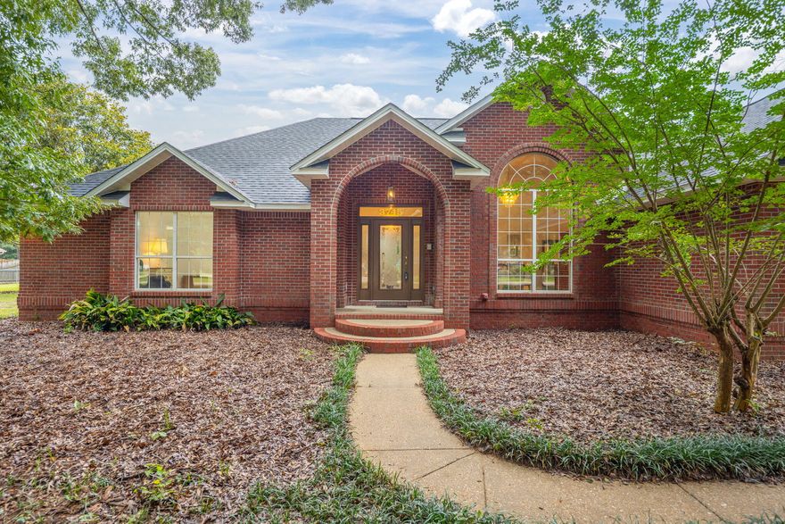 Nestled on a sprawling 1.8-acre corner lot with no HOA, this stunning brick home in Pace offers the perfect blend of privacy, charm, and space. With a new roof in 2024, new carpet, and fresh white paint throughout, this home is move-in ready! Surrounded by mature shade trees, the front yard and front exterior are comfortably nestled under a canopy of greenery, keeping the home cool and picturesque. Inside, you'll find four bedrooms all with walk in closets, three and a half bathrooms, and a spacious bonus room! A welcoming entryway with French doors and a chandelier opens into a bright, inviting floor plan. The kitchen features ample cabinetry, stainless steel appliances, and a breakfast nook tucked into a charming bay window overlooking the peaceful backyard. The formal dining room, jus t off the kitchen, offers elegance with a chandelier and a large window showcasing the front yard and mature oak trees. The living room is generous in size, complete with a tray ceiling, cozy fireplace, and built-in shelving. Adjacent to the living area, a screened-in patio offers a space to enjoy outdoor meals or unwind with views of the tree covered backyard. The split floor plan offers privacy for the primary bedroom, conveniently located near the laundry room. The en suite bath includes a double vanity, standing shower, soaking tub with a stunning stained glass window above it, and a private water closet. On the opposite side of the home, two spacious bedrooms each have walk-in closets and their own vanity and toilet, connected by a brand new shared tub/shower combo. Above the oversized two-car garage, you'll find a private fourth bedroom with a full bath and walk-in closet, plus a large bonus room with recessed lightingideal for storage, or a playroom. Outside, the fully fenced backyard includes a large shed, and paved access for a car, boat, or RV. Located on a quiet street off Berryhill Road, this one-of-a-kind property offers peace, space, and convenience all in one!