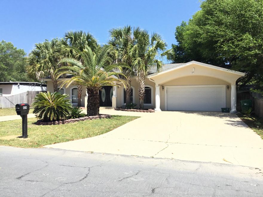 Mediterranean Style one-story home on HUGE LOT!! This spacious 3 bedroom 2 bath home has columns and arches dividing the open living areas. The living room has hardwood floors, custom crown molding, chair molding, and hardwood ceilings. The kitchen is a chef's dream... Stainless steel appliances, Refrigerator, Convection Oven, Micro hood, and Cook-top -- All built into beautiful custom cabinetry and impressive imported tile countertops. Plenty of kitchen cabinet space and walk-in pantry storage. This home also has a large laundry room and an OVERSIZED two car garage with automatic opener and keypad exterior entry. The double gated fence opens on the side of the home with room to park a boat or an extra vehicle. The home also offers a circular drive for easy access and entertaining.