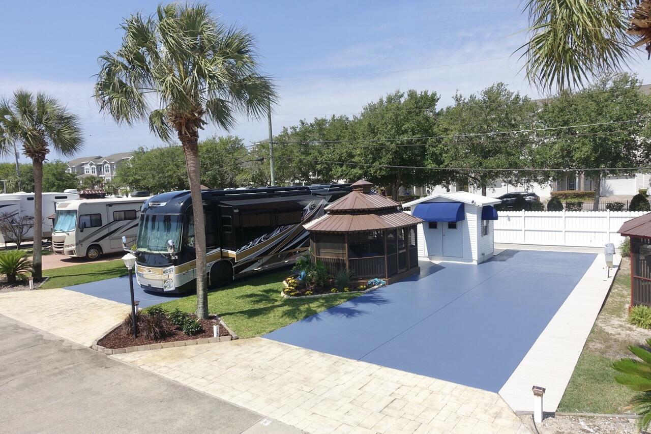 Gulf Of America -2 blocks away- the Exclusive 'Class A'/'Super C' Motorhome, 15 Lot NON-Rental Gated Community, with a Pool. One of the nicest lots on West side of the community, Lot 13 is loaded with upgrades. RV Pad was recently coated with Epoxy finish, High End Composite Decking recently installed around it, new Landscaping, new Electrical Power Pedestal Panel & added GFI protection. RV Pad recently recoated with Epoxy Finish & extended to accommodate Luxury Length Motorhomes with ample space. Lot 13 has been recently upgraded with many nice enhancements: furnished Gazebo has been refinished & has a new Metal Roof; New AC unit in Storage house w/ a new Metal Roof; High End Composite Decking recently installed around Gazebo & Storage House offering smart usable space; new Electrical Power Pedestal Panel & added GFI protection. Gated Community with Palm trees, sprinkler system, Pool, Pool House with Laundry, Restrooms & Shower. $2500 Yearly HOA Fees include Ground Keeping, Irrigation, Security Gates, Community Pool, facilities, Sewer, Water & Trash. Owners Pay Electric & Cable. 2 Pets with Breed Approval. NO 5th Wheels/trailers. Located 2 blocks from 1 of South Walton's largest Public Beaches with parking, public bathrooms and Pompano Joe's Beachside restaurant. Enjoy snorkeling at the Manmade Reef. Scenic Gulf Drive has Bike/Pedestrian Paths along the road offering beautiful Beach Views. Buyer Pays $500 Capital Contribution at Closing.
