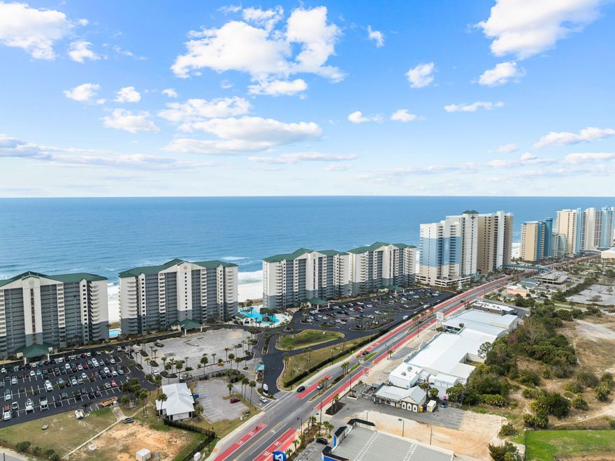 Boasting a larger-than-average balcony, this gulf-front condo is superbly located for enjoying direct views of the white sandy beach, dunes and breathtaking Gulf of Mexico from your own private space. The well-designed living area has been updated to include new LVP flooring, shiplap and chic decor in a soothing palette of colors. Behind the sleeper sofa, a mirrored wall enhances light and space, complementing the trio of sliding glass doors. Step out onto the balcony that extends across both the living room and master bedroom. There's ample space for lounging, dining and reading beneath gently turning fans. The generously sized master bedroom has an updated ensuite bathroom with twin vanity and shower over the tub.