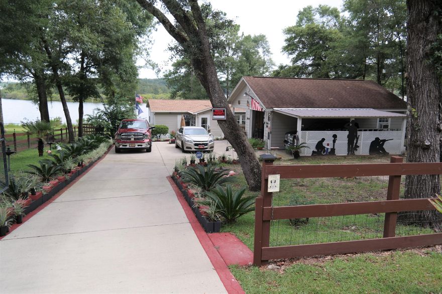 This amazing King Lake waterfront home on 1/2 acre fenced lot is an absolute must see! Exterior features include detached garage with carports on both sides, shop area & full bath; concreate walkways around home & to the dock; 12x15 open deck overlooking the lake; beautiful landscaping; Screened porch; New roof 2016; security system. The home & lot are both immaculately maintained. The 3 BR, 2 bath home features a roomy foyer; open floor plan,; walk-in closets in all rooms; 2 pantries, separate entry at laundry room. Master bath has garden tub & separate shower. Words can't encompass everything that this home & property have to offer. This one won't last long on the market so schedule your showing today...you won't be disappointed! This home qualifies for FHA & VA financing!