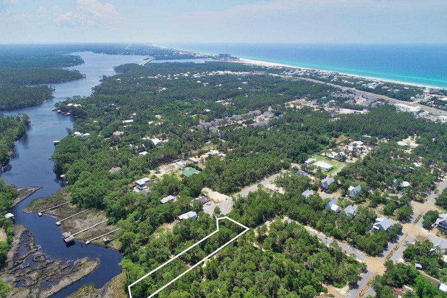 Located on Lake Powell in Inlet Beach, near 30Avenue Shopping area. With 63' fronting Lake Powell, this deep .58 acre wooded lot is located in the gated community of Sweet Bay. A fantastic location on a quiet culdesac affords you easy access to the great restaurants and shopping of Inlet Beach and 30-A. Build your new primary or secondary residence with boat dock in the secluded setting of Sweet Bay!