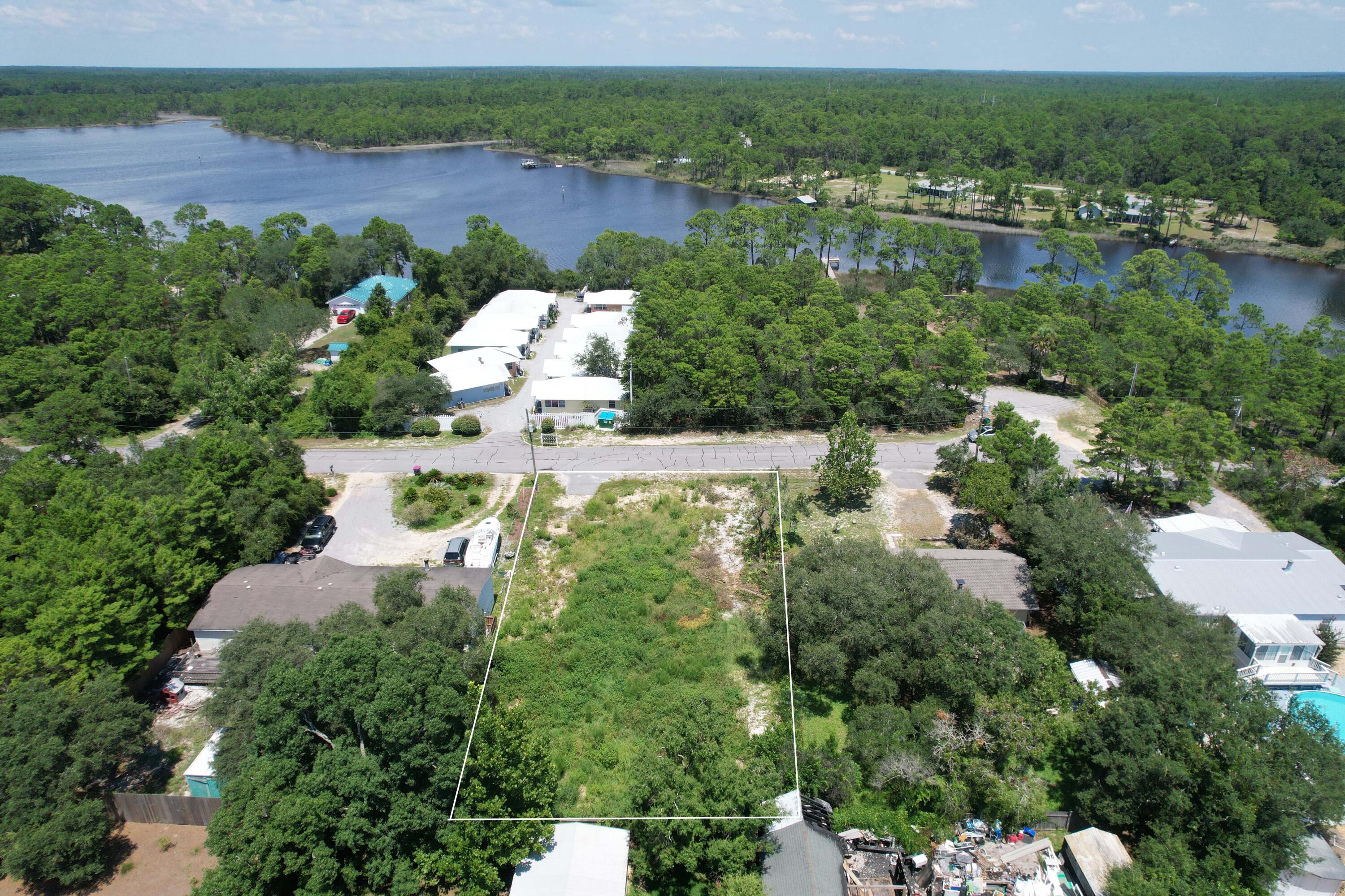 West End Panama City Beach!!! This fully cleared lot is perfectly positioned to take advantage of both the beach and Lake Powell!! One could enjoy all the comforts of a newly constructed home with potential views of Lake Powell. The public lake access is located just down the street with easy entry to relish a day on the water either fishing, kayaking, paddle boarding, boating or just enjoying the sites and sounds. Zoned R-4, this property has multiple uses perfect for a short term rental duplex or home. The lot is 80x150 with an updated survey and sold with house plans ready for permitting. No HOA and no buildout time.