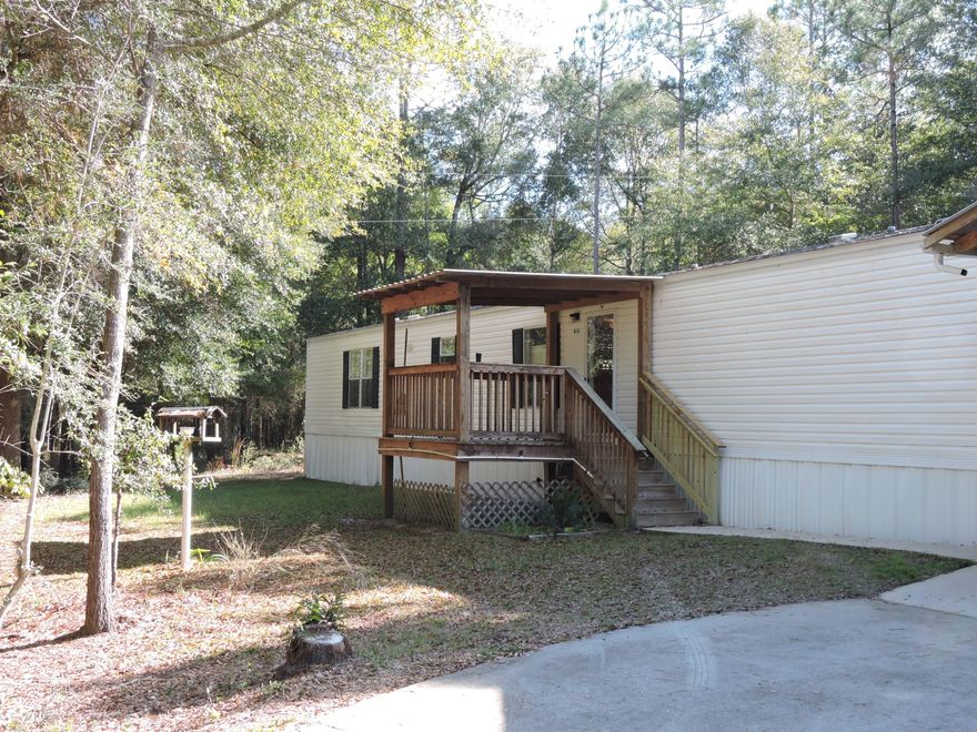 Well maintained 2003 built 3 bedroom, 2 bath mobile home on a 1 acre lot within 2 miles of the Holt exit on I-10. As you pull up to the property you will notice the concrete driveway, Carport/Storage Shed, aw well as the nice covered deck off the the front door. As you enter you will find a spacious and inviting open concept living room/dining room/ kitchen area. All appliances convey with sale (self cleaning smooth top stove, microwave, dishwasher, side by side refrigerator with icemaker, washerand dryer). The home also features central A/C as well. The home includes a well (for irrigation) and generator in shed outside rear door. The storage shed has power.
