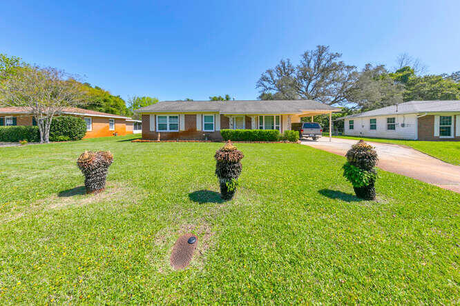 Location, Location, Location! (The old cliche perfectly fits)! Welcome to your new home ... ideally located near schools, parks situated on a tranquil, non-thoroughfare street in the heart of Ft. Walton Beach! The front of the house is red brick with an inviting large front yard. Inside is a well-thought-out, functional open floor plan that feels much bigger. It's replete with a large living room & over-sized front windows and a spacious kitchen. Attached is a carport with an enclosed laundry room adjoining.