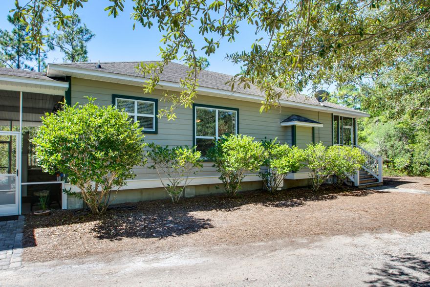 Lovely custom built Florida cottage home in The Woods, a neighborhood of 46 lots on 56 acres, four miles north of Grayton Beach. There is a Bayfront community park and dock on the Choctawhatchee Bay. This home is nestled quietly on a half acre lot and surrounded by a natural preserve. Lot has potential for a carriage home. Or plenty of room for a pool. There are two screened in porches. One awesome wraparound porch at the front of the home with a sweet porch swing, the other porch bridges the gap to the garage. Home has a fresh coat of paint, new stainless steel dishwasher, microwave and stove. Built-in propane fireplace in the family room for those cooler nights. The hardwood floors are absolutely