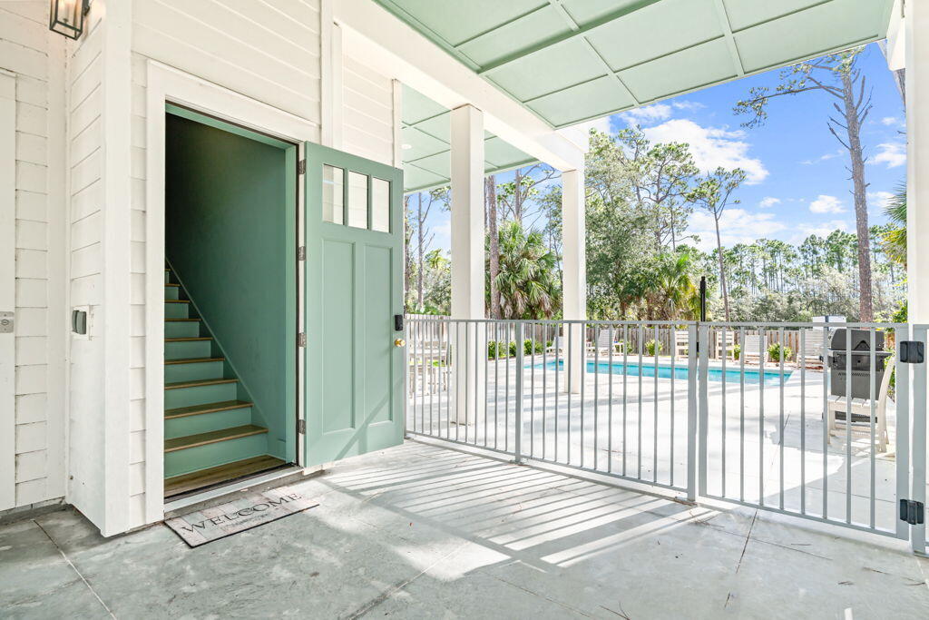 This 5 BR, 4 baths coastal home by Ben Wortman Construction offers over 4,200 sq. ft. of thoughtfully designed living space. Inside, you'll find a gourmet kitchen with stainless steel appliances, a large island, and a wet bar, perfect for entertaining. The vaulted ceilings, open dining area, and covered porch with Gulf views create an inviting atmosphere, while the large laundry room adds convenience for everyday living or extended stays. Step outside to a fenced backyard with an in-ground pool, or take advantage of your deeded private beach access just moments away. An elevator makes the spacious layout easily accessible. Whether it's a vacation rental, investment property, or personal beach home, this has it all!
