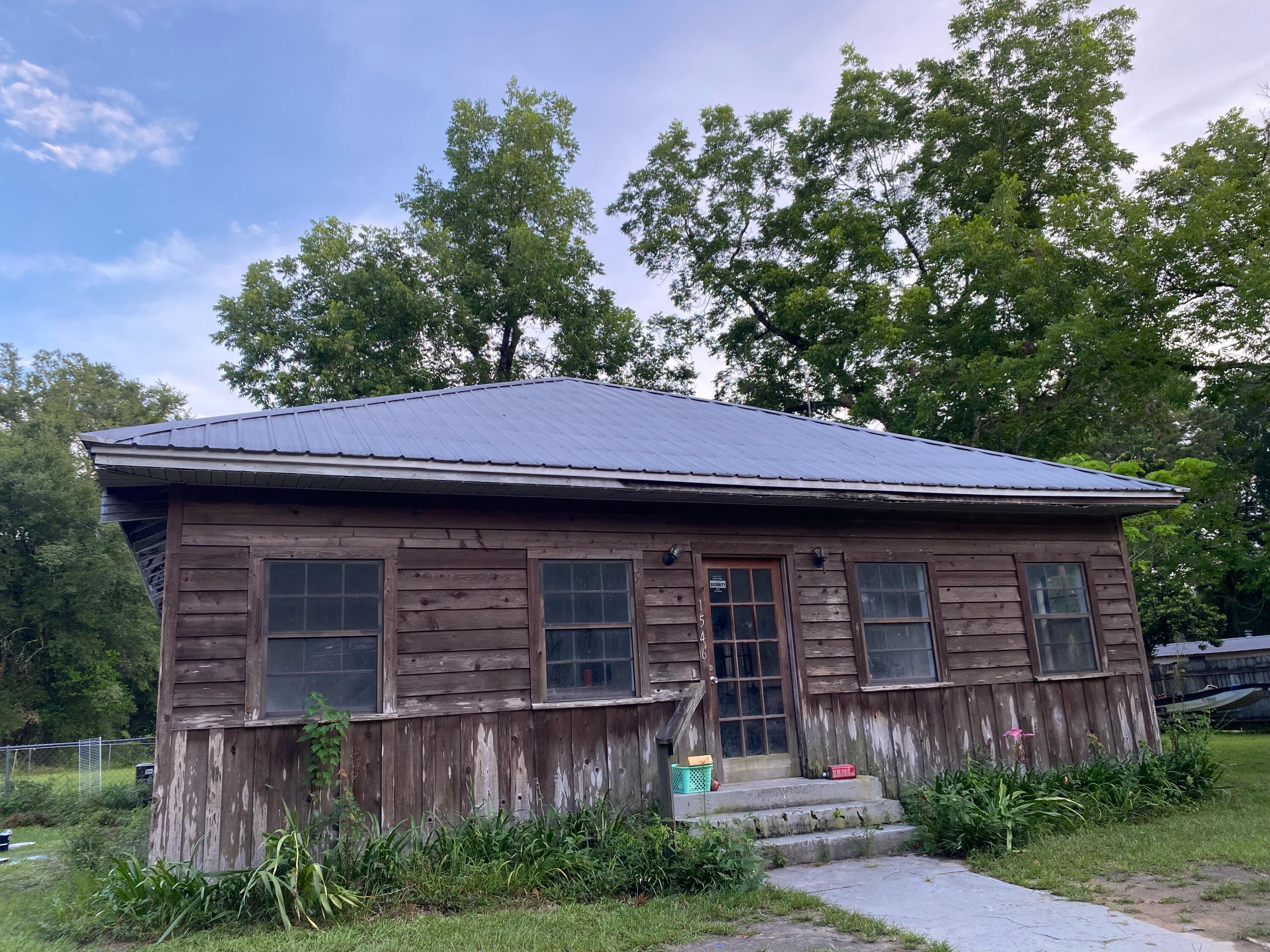 Priced to go quickly! Great income Property or your starter home. Close to HWY 90, i-10, gorgeous springs, and apx 45 minutes to the beach! Could be converted into duplex.Plenty of space in back yard to add a ADU. (Partial chain length fence separates the lots.)(DD on zoning restrictions and local laws.)Home is currently livable but has partially primed rooms.Front room is a 'Fl room' with windows and heart pine floors. Could easily be converted into extra office and-or bedroom.Primary bedroom features a double reach in closet as well as a full walk in that serves as a bonus space. Home needs new flooring in most rooms. Much work to be done and priced with that in mind!Great bones and great lot with nice neighbors and wooded area in back.