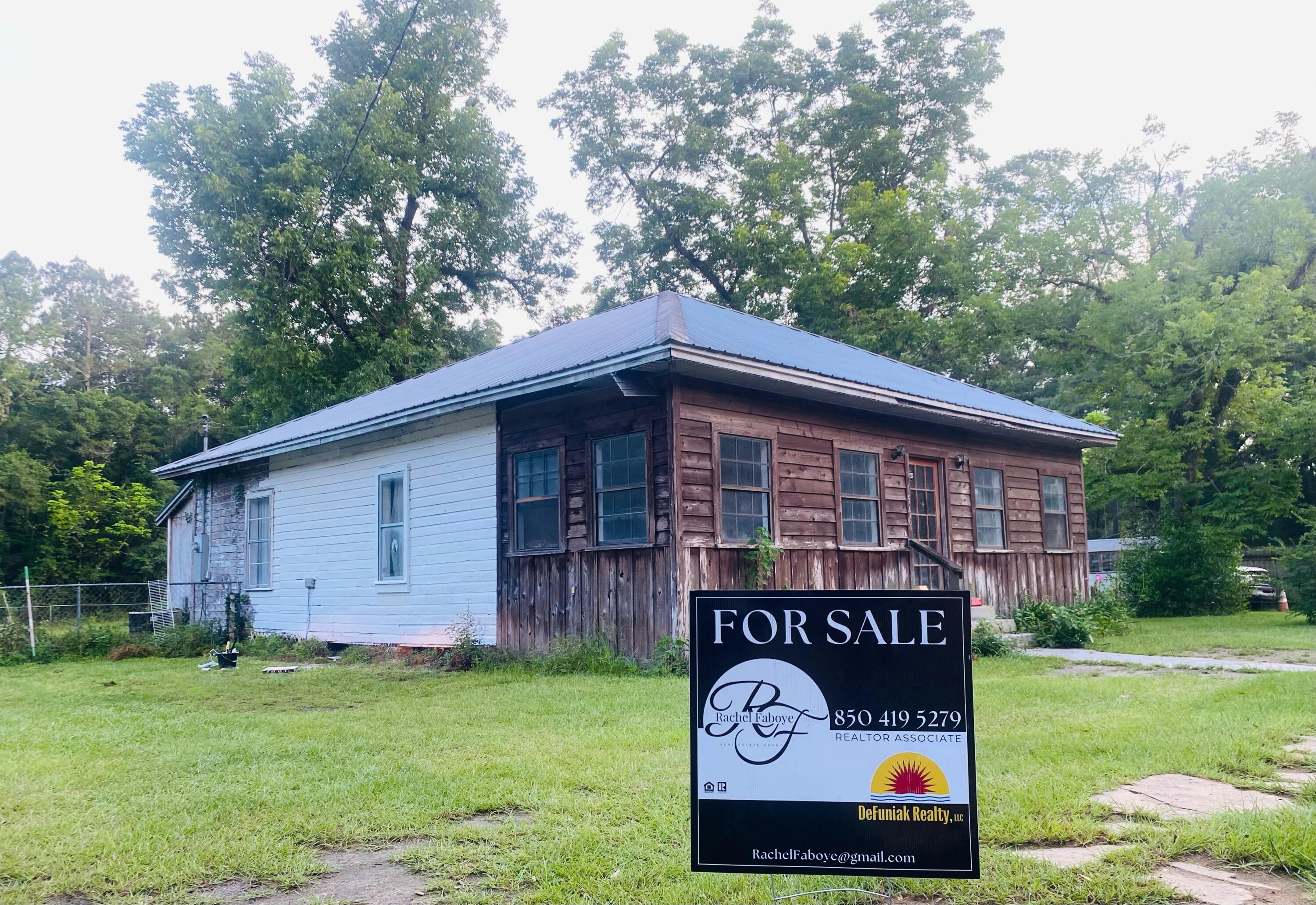 Priced to go quickly! Great income Property or your starter home. Close to HWY 90, i-10, gorgeous springs, and apx 45 minutes to the beach! Could be converted into duplex.Plenty of space in back yard to add a ADU. (Partial chain length fence separates the lots.)(DD on zoning restrictions and local laws.)Home is currently livable but has partially primed rooms.Front room is a 'Fl room' with windows and heart pine floors. Could easily be converted into extra office and-or bedroom.Primary bedroom features a double reach in closet as well as a full walk in that serves as a bonus space. Home needs new flooring in most rooms. Much work to be done and priced with that in mind!Great bones and great lot with nice neighbors and wooded area in back.
