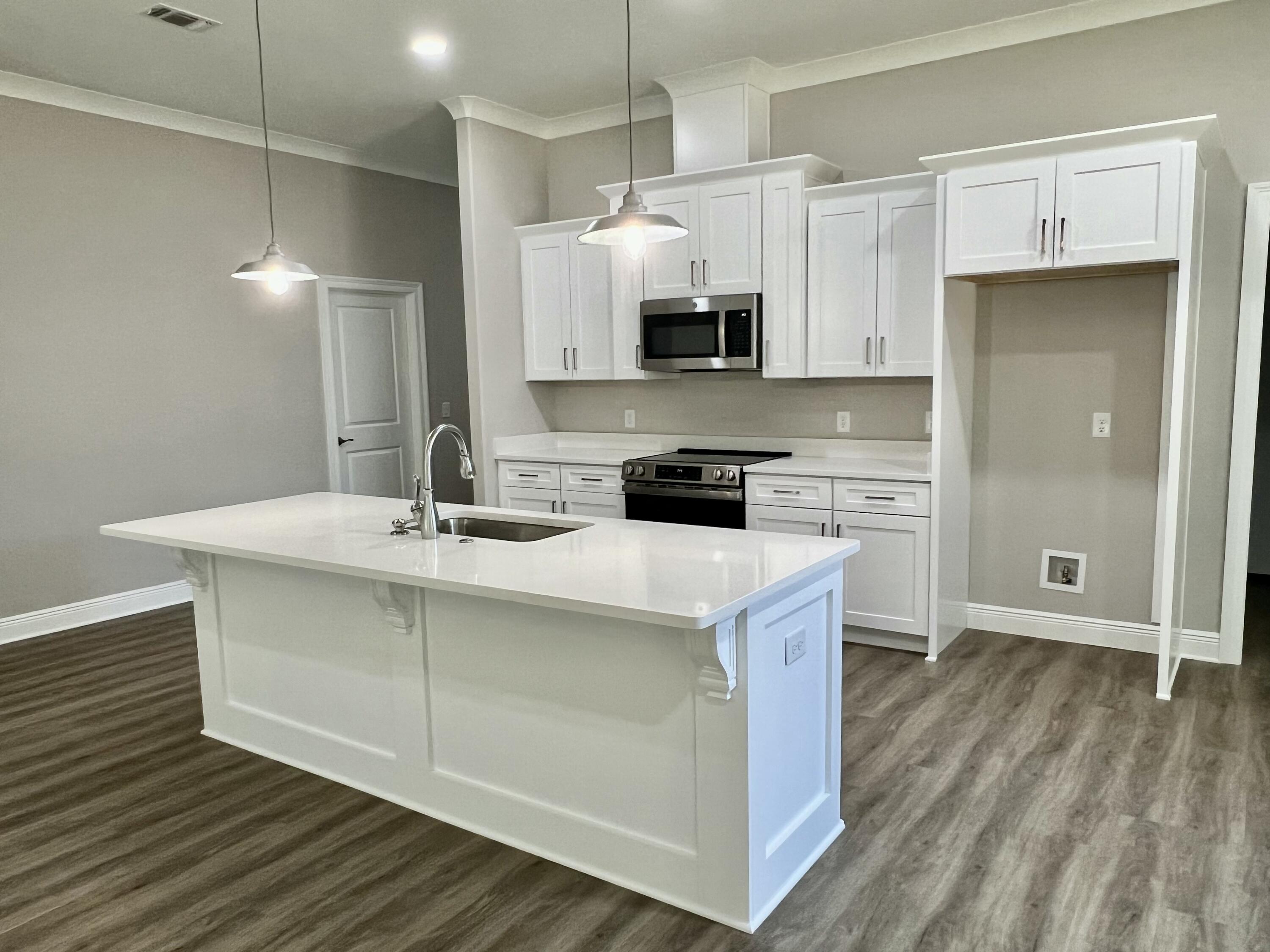 NEW CRAFTSMAN Custom Built Home ~ this luxurious 3 bed/2 bath floor plan is under construction ,end home of 4 new builds and will be ready in time for your Spring move in ~Great Central Location with easy access to Navarre Beach, Navarre Waterfront Park and Hwy 98 to Hurlburt Field AFB.This Stunning Robbins Builders Home offers trend setting features~Greeted by a walk in foyer sweeping through to your open floor plan ~Large kitchen enjoying custom cabinets with crown molding, beautiful granite counter tops~under mount sink~S/S appliances, large double door pantry & closed off utility room ~sleek top center Island with pendant lights ~open flow to the family room with patio doors out to the large covered porch .Wood look LVP throughout with tiled bathrooms~ Large master with trey ceiling /ceiling fan and large walk-in closet ~master bath offers an oversized TILED shower ~ double vanity with picture frame mirrors. Additional Bedrooms are a great size with double closets and ceiling fans~Home has a welcoming covered front porch and large covered back porch to sit out and enjoy those wonderful Florida evenings ~great to cook out and entertain. Grassed yard with irrigation system for easy care in the summer months. TAEXX in wall pest control system~ Hurricane protection for windows and dimensional shingle roof for lower insurance premium. Upgrades throughout include recessed lighting, bedroom fans, crown molding, deluxe lighting package,50 Gallon water heater, garage door remotes, attic drop down stairs~ to name a few.....Call today for further information.