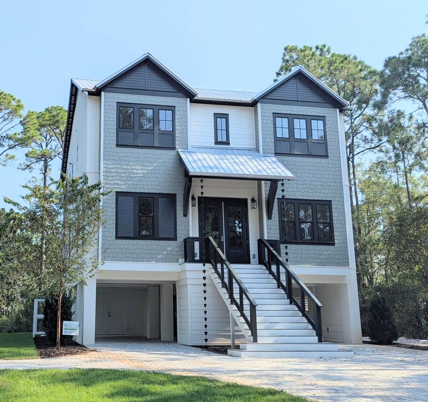 Amazing NEW CONSTRUCTION home tucked away on half an acre lot. This custom 5 bedroom,3 1/2 bath home would make for an excellent primary residence, second home or investment property. The bottom floor features a saltwater swimming pool and full-size kitchen with bar sitting area for entertainment finished with built-in Sonos speakers, covered parking, storage and half bath. First floor consists of a large primary suite with a private en suite bathroom featuring a wet bath, French door to oversized porch and two more bedrooms. The top floor features an open kitchen-living area designed for both elegance and functionality, custom cabinets, pristine quartz countertops, large island, sleek stainless-steel appliances, wet bar, pantry and three more bedrooms. The top and bottom levels feature expansive porches, offering a delightful space for relaxation and enjoyment. The kitchen/living area has a 12 ft Euro Glass Wall that opens to the porch bringing the outdoors in.
