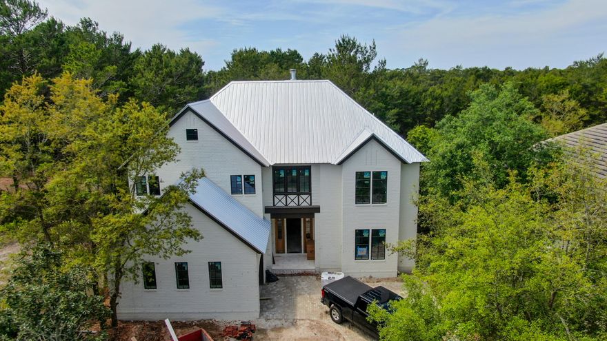 Stunning new construction in the beautiful gated lakeside community of the Landing at Camp Creek. Future residence will enjoy breathtaking views of one of the rare coastal dune lakes from this property. The well thought-out floor plan offers 4 bedrooms and 3.5 bathrooms as well as 2 living spaces and an incredible outdoor living area. Features include a large open concept living space, 2 large master suites, a garage, designer finishes and luxury fixtures. The striking exterior of the home showcases the beautiful white brick faade, copper lanterns, large windows, brick paver driveway, custom trim and astonishing architecture.As you enter the home you will be welcomed by the amazing ceiling height in living room. The open concept first floor living area offers a