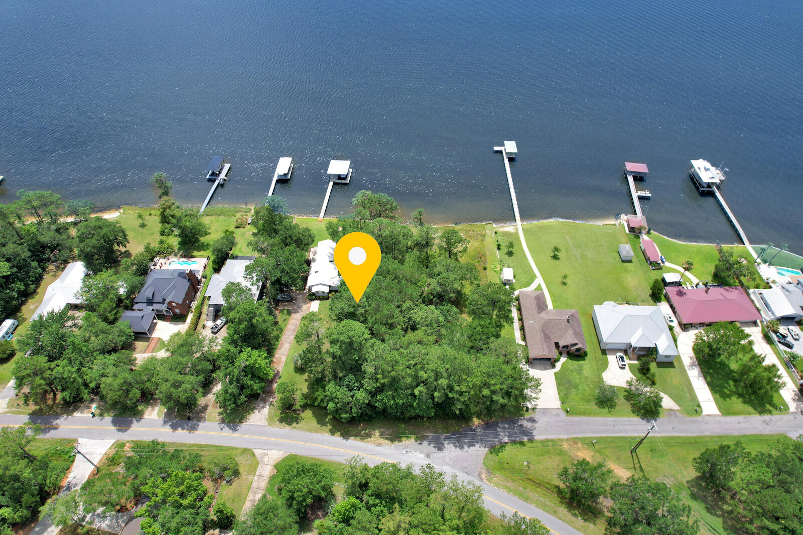Tired of the congestion and tourism? This is one of the few remaining LARGE parcels on the water on the highly coveted Bay Grove Rd. With a newer seawall in place and endless sunsets, come build your dream home directly on the Bay! This one won't last long.