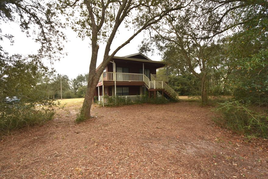 Watch the planes taxing in and out from the balcony of your home! What a great place for the weekend pilot-just build your hangar or park your airplane on your property. This 2-story home is nestled among the large shady oak trees with a balcony, covered deck, and detached deck to enjoy the quiet country and bordering airstrip. The original house was built on pilings, the bottom floor enclosed (on a concrete slab) in 1992 approximately. Spiral staircase from the original 2nd BR upstairs (called the Bonus Room) to the downstairs laundry room. Upstairs is a central heating unit, plus there are 4 window air conditioners and 3 space heaters in the home. Airstrip and road cover approximately .55 acre, leaving .64 acre of usable property. Interior pictures to be posted the week of Feb 18th.