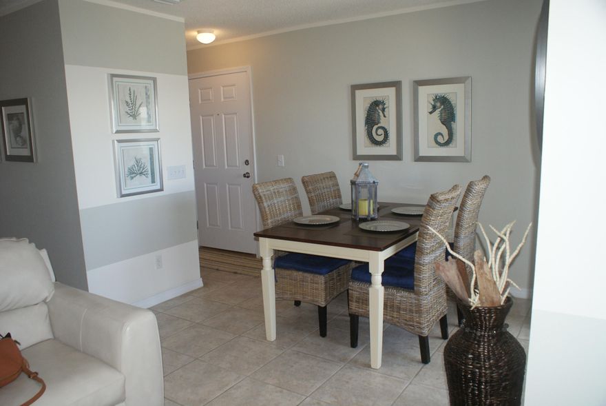 Beautifully decorated with a short walk across the street to the sparkling waters of the Gulf of Mexico. Entering the condo, you will find an ample living area with a bright, white kitchen recently updated with glass tile back splash, new ceiling fan, lights, and new cabinet pulls. There is a breakfast bar in the kitchen plus a dining area which opens up to the balcony. The master bedroom has its own full bath and another full bath in the hallway for guests. There is a set of bunk beds recessed in the hallway for extra guests plus the couch in the living room opens up to a bed. Also in the condo is a stackable washer and dryer. Only the master bedroom has carpeting; the rest of the flooring is tile. This condo is the seller's second home and has not been rented out.