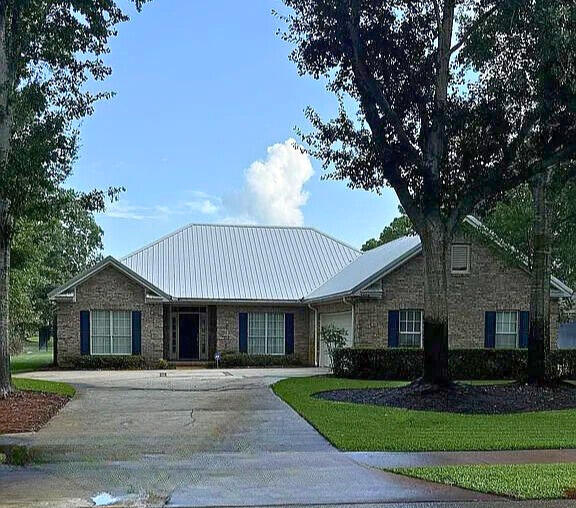 **Single-Owner Home in Bluewater Bay with Pond Views & Bonus Room**Located in sought-after Bluewater Bay, this 3-bed, 2.5-bath home features a split floor plan, spacious primary suite with walk-in closet, and dual sinks in both full baths. The eat-in kitchen offers new granite counters, breakfast bar, and a second sink ideal for a wet bar or coffee station. Enjoy the enclosed 4-seasons bonus room (237 sq ft) overlooking a peaceful pond on a level 1/4-acre lot.Upgrades include metal roof (2018), HVAC (2023), and gas water heater (2022). Oversized garage with rear golf cart door. Coffered ceilings in family room and primary bedroom. Termite bond in place since construction. Just a short walk to pickleball courts and the club house. A quick drive to the marina, community pool and the Destin Beaches. Zoned for top-rated schools.