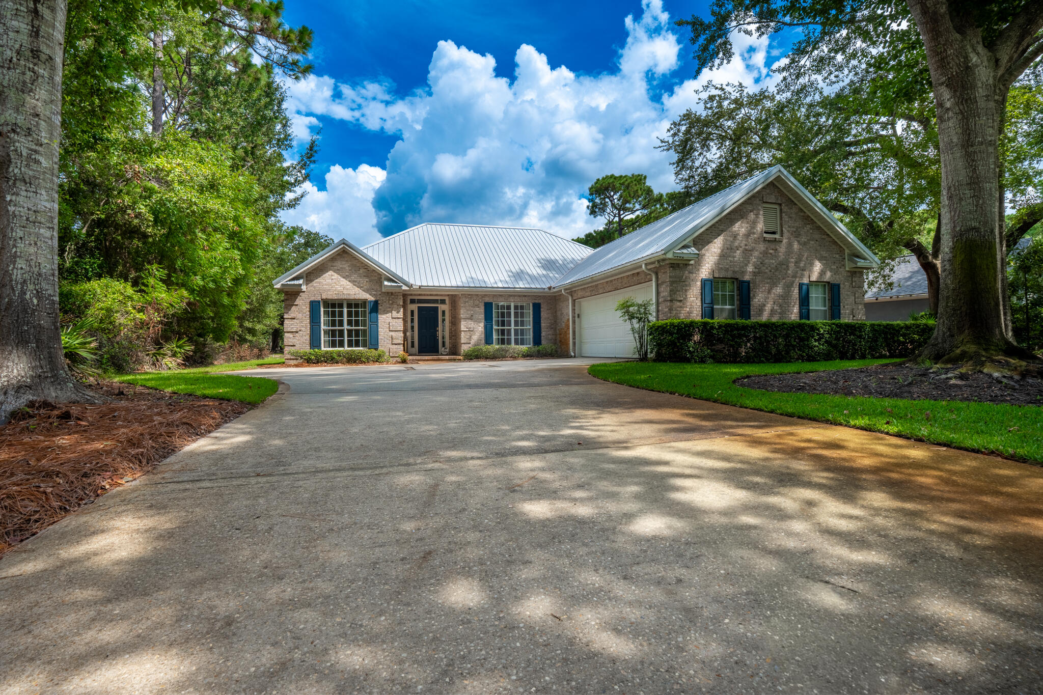 **Single-Owner Home in Bluewater Bay with Pond Views & Bonus Room**Located in sought-after Bluewater Bay, this 3-bed, 2.5-bath home features a split floor plan, spacious primary suite with walk-in closet, and dual sinks in both full baths. The eat-in kitchen offers new granite counters, breakfast bar, and a second sink ideal for a wet bar or coffee station. Enjoy the enclosed 4-seasons bonus room (237 sq ft) overlooking a peaceful pond on a level 1/4-acre lot.Upgrades include metal roof (2018), HVAC (2023), and gas water heater (2022). Oversized garage with rear golf cart door. Coffered ceilings in family room and primary bedroom. Termite bond in place since construction. Just a short walk to pickleball courts and the club house. A quick drive to the marina, community pool and the Destin Beaches. Zoned for top-rated schools.