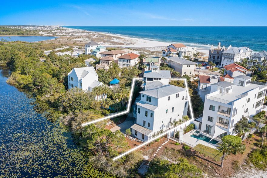 30A RENTAL REVENUE GIANT! A prime south of 30A location in the gated community of Seclusion Dunes, bordering the rare and special Gulf-front preserve lands of Deer Lake State Park. With established rental revenue of +$343,000, trending to exceed $370,000, this is a strong vacation rental performer.  Situated with the lake along the rear and just steps to the beach, this incredible coastal retreat boasts stunning Gulf and lake views and has enough space to accommodate up to 35 people. The custom designed outdoor living of this residence is impressive and unsurpassed, with multiple decks, an elevated pool deck thoughtfully positioned overlooking the lake, and two separate wet bars.The first level houses a massive bunk room with bath, generous entry space and the garage space.