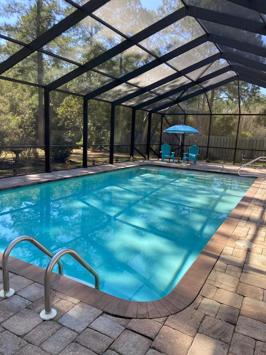 This lovely 5 bedroom, 3 bath, single story, much sought after McKenzie model home with a screened in pool awaits your visit! It is nestled in the Whispers neighborhood of Hammock Bay on a cul de sac backing to a private wooded preserve. From the freshly painted front porch to the spacious paver surrounded pool, this home is ready for you to entertain family and friends year round. Stainless appliances will contribute to your culinary successes. Granite surfaces and tile flooring in the kitchen and baths and trey ceilings and moldings add to the homes gracious ambience. The fenced backyard provides plenty of space for play and relaxation. Hammock Bay is the premier lifestyle community in northwest Florida with unparalleled amenities and features! Come see!