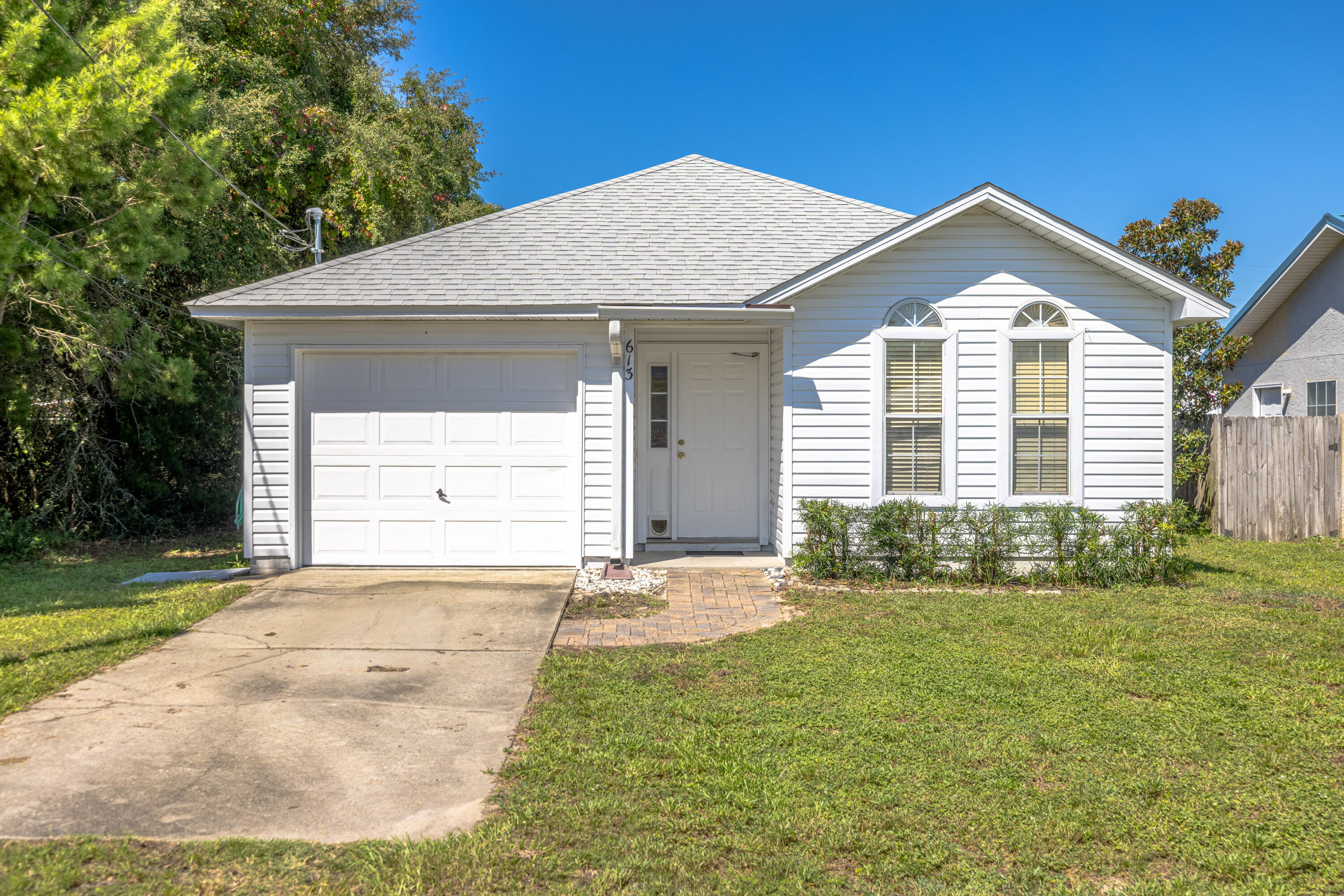 Welcome to 613 Dolphin Drive! This charming 3-bedroom, 2-bath home is located less than a mile from the sugar-white sands and emerald waters of the Gulf and only a few blocks to the renowned Lake Powell. With fresh paint,new flooring inside and a newer roof,large screen porch, fenced back yard with a shed this property is move-in ready and ideal as a primary residence, vacation home, or Short-term rental investment. Step inside to find a bright, open layout with plenty of natural light and space to gather. The home features a one-car garage, spacious patio for outdoor entertaining, and low-maintenance living so you can focus on enjoying the beach lifestyle. Lake Powell is nearby with a public Park with picnic tables, swimming area, boat ramp and kayak launch.. (CONT IN ADD. REMARKS)...... Pier Park, the 30A corridor, Walton county public beach ,TopGolf, and Dolly Parton's Pirates Voyage are all just moments away. With countless dining, shopping, and entertainment options within easy reach, this location is truly unbeatable!! Whether you're looking for a darling beach retreat or an income-producing property, this home checks all the boxes!
