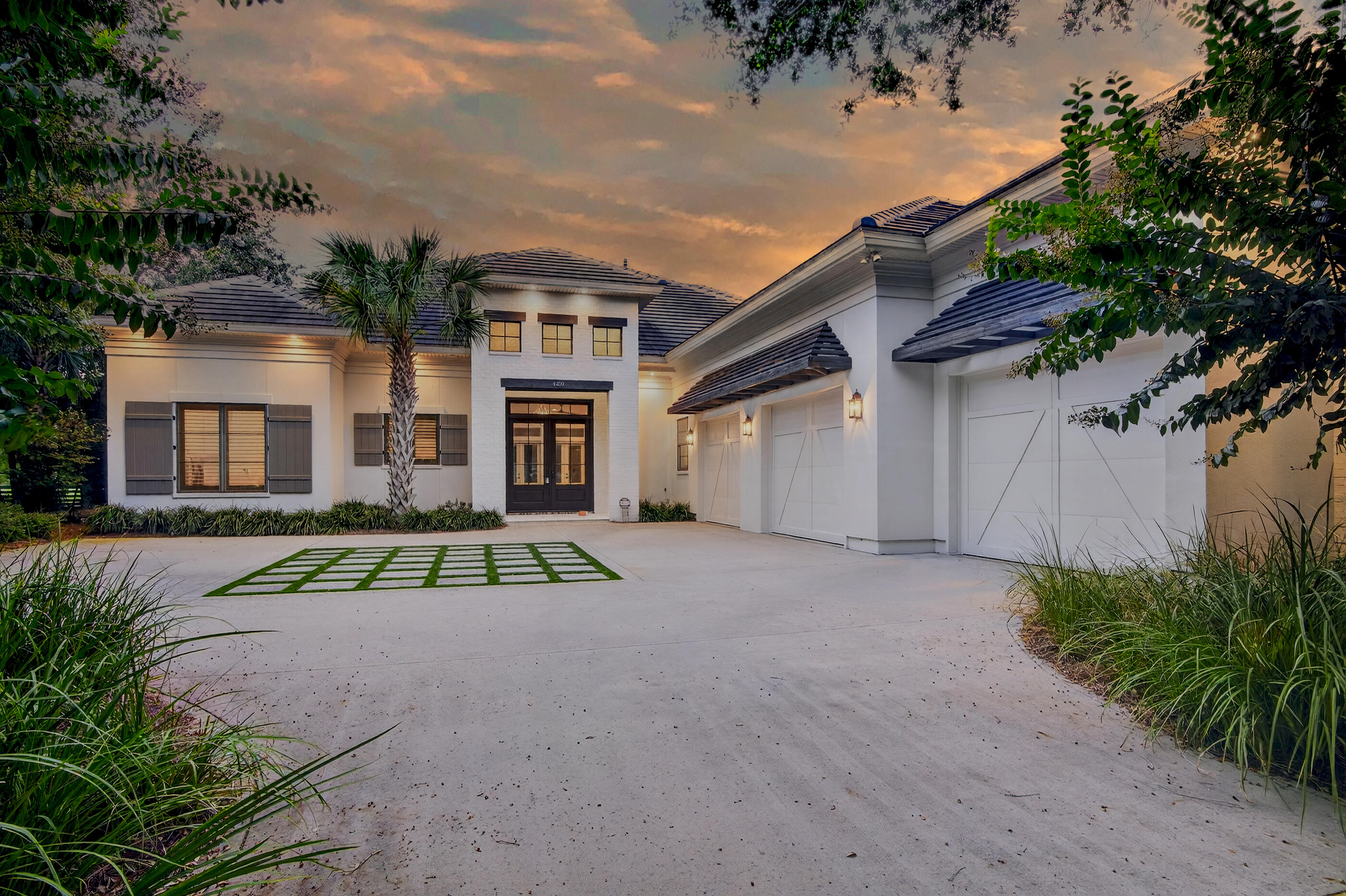 Discover the perfect fusion of modern elegance and artistic coastal contemporary design in this remarkable lakefront residence. This newly built home sits on one of the premier lots in Regatta Bay and offers both lake and golf course views. The home is located within the prestigious gated golf and boating community of Regatta Bay. Completed in 2016, this meticulously designed home showcases an open floor plan with the majority of the home located on the main level. The thoughtfully arranged layout features four bedrooms and four and a half bathrooms, enhanced by clean lines and exquisite designer finishes throughout. This designer finished property boasts remarkable features, including soaring 12-foot ceilings on the main level and an oversized three-car garage with ample parking. The interior showcases elegant hardwood flooring throughout, leading to a spacious living room that is anchored by a contemporary gas stone fireplace. This inviting space offers seamless access to an expansive screened lanai, showcasing 650 square feet of outdoor living space adorned with pecky cypress ceilings and beautiful views. The outdoor area is further complemented by a secondary gas fireplace, pool and hot tub, perfectly positioned to capture breathtaking western sunsets and picturesque views of the lake and multi award winning golf course. The designer kitchen is a culinary dream, with custom built cabinetry, Calcutta marble countertops, 60-inch Wolf gas range and a built-in Sub-Zero refrigerator. The kitchen flows effortlessly into the open dining room and includes an oversized pantry with premium storage options. The master suite radiates coastal charm with and a spa-like master bathroom complete with a luxurious soaking tub, dual vanities, chevron-pattern marble flooring, and an oversized walk-in shower adorned with hand-hewn beam accents and dual shower heads. The 13x16 master closet is a standout feature, offering direct access from the master suite and showcasing custom-built shelving along with a center island for optimal storage. Additionally, the laundry room conveniently connects to the master closet for enhanced functionality. On the second floor, you will find two additional bedrooms each with en-suite bathrooms, as well as a flex space. Regatta Bay is a serene, gated community that seamlessly blends golf and boating, offering a lifestyle that is truly unparalleled! The essence of the Regatta Bay Lifestyle revolves around convenience, allowing residents to easily access numerous enjoyable destinations within minutes via golf cart, including the beach! Within the community, residents can indulge in golf, swimming, tennis, pickleball, parks, playgrounds, the Regatta Bay Clubhouse, Legendary Marine, and Legendary Yacht Club. Furthermore, Regatta Bay features a private road that leads directly to the Destin Commons, where an array of popular retail stores for both men and women awaits, alongside a diverse selection of restaurants, Whole Foods, Bass Pro, Lowes, an AMC movie theater, and Uncle Buck's Bowling-all easily reachable by golf cart. Regatta Bay is centrally located offering easy access to the airport and only a few miles from Northwest Florida's finest hospital.