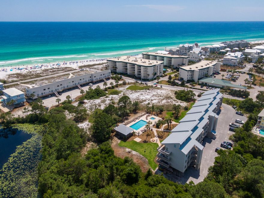 GULF VIEW & UNDER $1mThis 2 bedroom 2 full bath condo is over 1000 sq ft and 1/2 block to the sugary white sands and crystal clear waters of the Gulf of Mexico! Offered beautifully furnished and featuring a large open floor plan highlighted by windows and french doors along the south wall. There is an oversized balcony overlooking the newly updated community pool and hot tub, shared pavilion and lush landscaping. The kitchen has been recently updated to feature stainless appliances, shaker cabinets, and white subway tile. Bonus, this unit has in-unit laundry in the guest room closet.