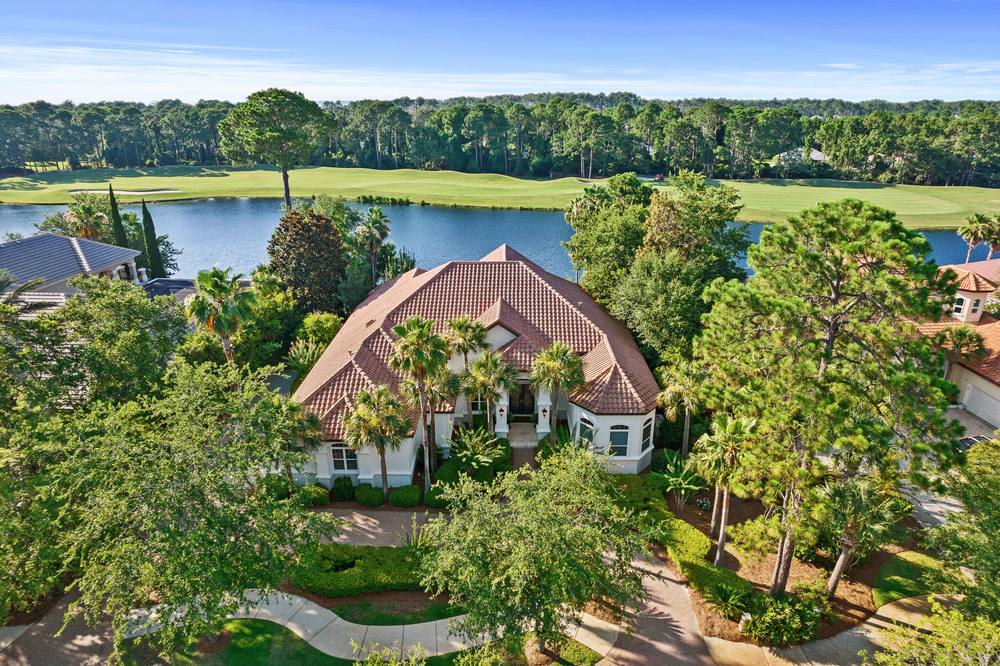 Overlooking the 5th fairway of Burnt Pine beyond the largest lake at the Rees Jones course is this custom built, fully renovated Boswell home. With an open floor plan suited for today's lifestyle, this 4,981 square foot home offers thoughtfully designed and furnished spaces that flow easily for entertaining and an oversized three car garage. The lakefront location and outdoor swimming pool provide peaceful views through floor to ceiling windows. A full renovation was completed in 2020 reflecting timeless details and finishes in each room. The main level features a formal living entrance, formal dining room, custom Wolf-Sub Zero kitchen, spacious master bedroom suite, two guest bedroom suites, laundry room, mud room, and access to the covered outdoor living area and pool with screened