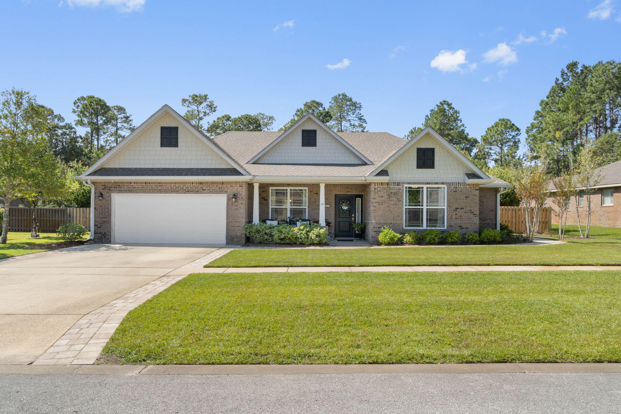 Gorgeous Hammock Bay home featuring upgrades galore! Brand new  flooring, custom lighting, electric fireplace, tucked away in the serene section of Harmony with a private, fenced yard highlight some of the wonderful features of this home. With a spacious home office, gourmet kitchen, sunroom, and outdoor firepit, you won't want to miss out! Custom bookcases surround the cozy fireplace and accentuate the open floor plan. Pre-wired for alarm system. Perfect for entertaining and enjoying all life has to offer. Hammock Bay is a master-planned community with 3 pools, playground, clubhouse, tennis and pickle ball courts, new gym, dog park, and resident events.