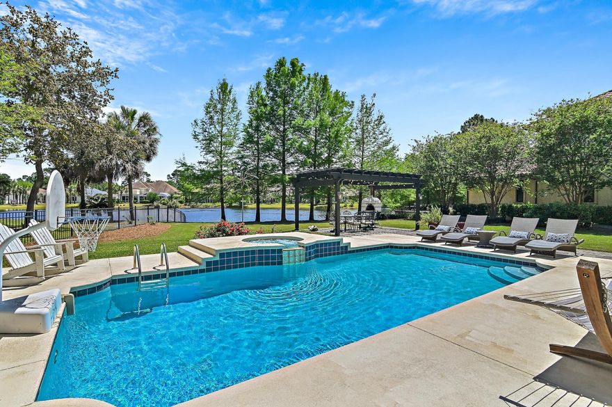 Welcome home to this large Southern Traditional designed family home, located on a quiet lake in the exclusive gated golf community of Regatta Bay. A NEW CONCRETE TILE ROOF HAS RECENTLY BEEN INSTALLED AND BOTH WATER HEATERS REPLACED! The back exterior is a nature lover's dream, offering heated private pool and spa, custom pergola, and a gorgeously landscaped fenced yard all overlooking the private lake. The main level offers a formal living room, den, dining room, office, half bath, and an attractively updated kitchen featuring Wolf and Sub-Zero appliances and quartz counters. The owners also added an enclosed custom built back porch featuring a built in grill, kitchenette, and a wood burning fireplace. The second level of the home offers 4 bedrooms, all with their own