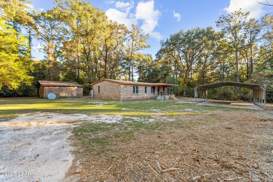 Discover peaceful riverfront living on nearly 4 acres with this beautifully updated brick home located just off Highway 20 at the Choctawhatchee River Bridge. Offering a rare combination of privacy, space, and convenience to nearby boat ramps, this property is ideal for anyone who loves the outdoors, working on projects, or simply enjoying a quiet, natural setting. Step inside to find a fully renovated interior featuring an open layout, new flooring, stylish lighting, and a large living area centered around a brick fireplace. The kitchen includes custom cabinetry, a center island, gas range, and stainless-steel appliances. Both bathrooms have been updated, with the primary bath offering a double vanity and walk-in closet. The expansive enclosed patio provides year-round enjoyment with floor-to-ceiling windows overlooking the wooded acreage. Multiple outbuildings, including a workshop, shed, and oversized RV/boat parking, create endless flexibility for storage, hobbies, and equipment. With direct river frontage and public boat ramps just minutes away, fishing, kayaking, and river exploring are all easily accessible. Additional features include a metal roof, private well, septic, natural gas, and plenty of parking for vehicles, trailers, or recreational gear. Whether used as a full-time home or a weekend retreat, this property offers room to breathe and a setting that's hard to find.