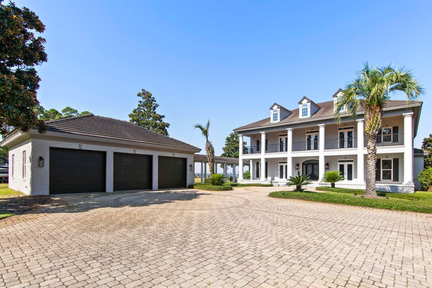 Experience luxury living on nearly an acre of prime bayfront property. This stunning estate features all new windows and doors, fresh interior and exterior paint, and a beautifully renovated kitchen designed for both style and function.Inside, a grand foyer opens to formal living and dining spaces, complemented by gleaming hardwood floors, a butler's pantry, and thoughtful details throughout. The home also boasts a private theater, spacious living areas, and double covered porches with sweeping water views.Outdoors, enjoy resort-style amenities including a sparkling pool with expansive patio, outdoor kitchen and bar, and a private dock with boat lift--perfect for embracing the coastal lifestyle.The gated drive leads to lush landscaped grounds with citrus trees and palms.
