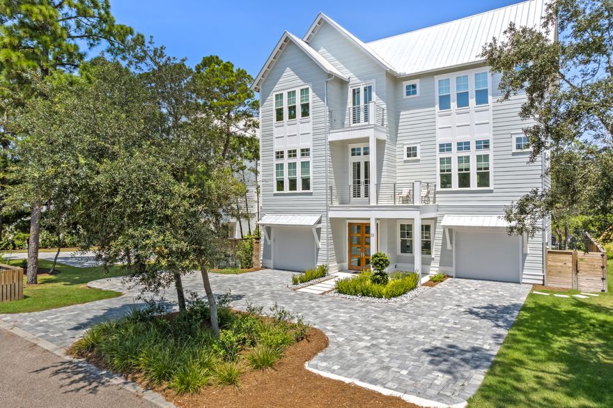 This exceptional 5-bedroom, 5-full-bath, 2-half-bath custom-built home offers the perfect blend of luxury, comfort, and flexibility. Completed in 2022, this 4,823 sq ft residence is ideally suited for a family home, second retreat, or investment property. This home is FULLY FURNISHED and includes modern upgrades such as a new roof, HVAC, and water heater. Upon entering, you are welcomed by a grand foyer that opens to an expansive 1,400 sq ft outdoor living area which features a saltwater in-ground pool, outdoor kitchen, fireplace, firepit, and serene pond views. On the second floor you'll find an open-concept kitchen, living, and dining area. The chef's kitchen is a standout, featuring a marble waterfall countertop, a large island, integrated refrigerator, walk-in pantry, lighted cabinetr y, and a double oven. The living area flows out to a nearly 450 sq ft covered patio, complete with a TV and fireplace, creating the perfect space for unwinding. The second floor also includes a luxurious primary bedroom suite, offering a balcony with peaceful pond views. The spa-like bath features a garden tub, separate shower, double vanities, and a spacious walk-in closet. The office on this floor is ideal for work or study and can comfortably sleep two guests. On the third floor, you'll find four additional bedrooms, including a bunk room, and a cozy family room. Four of the five bedrooms in this home feature ensuite bathrooms, providing privacy and convenience. High ceilings, intricate millwork, crown molding, wood accent walls, built-ins, and an elevator elevate the home's design, enhancing the luxurious atmosphere. For added convenience, the property includes three laundry rooms, two wet bars, six balconies, two separate garages, and three owners closets. Whether you're looking for a tranquil family haven, a vacation getaway, or a prime investment opportunity with high rental potential, this home delivers. With no HOA and a quiet street, it's the ultimate in coastal living.