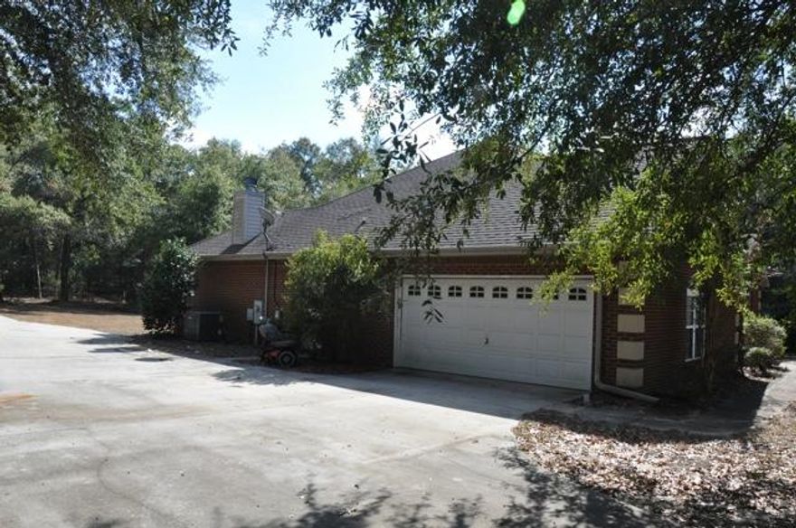 REO. Country charm! This all-brick home is located within the quiet subdivision of Hidden Springs and sits on one acre of land. The living room includes beautiful hardwood flooring and vaulted ceiling that make this large home feel even larger! The kitchen has everything you need to make meal preparation a breeze. Kitchen offers a ceiling mounted pot rack, kitchen island with a breakfast bar, cooktop, oven, and much more! There is an adjoining dining area complete with a fireplace, which can also be used as a living room... whichever suits your needs best!