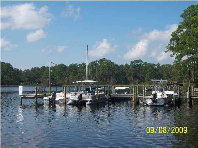 WATERFRONT Community and despite ''hidden'',very convenient! Unit provides sunrise view of dolphins,pelicans and Tom's Bayou from your bedroom window! Eglin AFB gate is 6 minutes away. The Hidden Cove club house, dock and pool are a 2-minute stroll as you watch cormorants dive for their lunch. Holiday parties are common and a modest fee to rent clubhouse. Unit #30 has light hardwood flooring in living area and built-in bookshelf/cabinets, (BR #2). Kitchen has been remodeled and laundry units less than five years old. Tenant will be out, early January. Lawn maintenance and irrigation, not your worry either.(part of HOA fee) Flood insurance is required at approx $214/yr. (However,the unit has never flooded). Buyer to verify all details! Dimensions from public records.