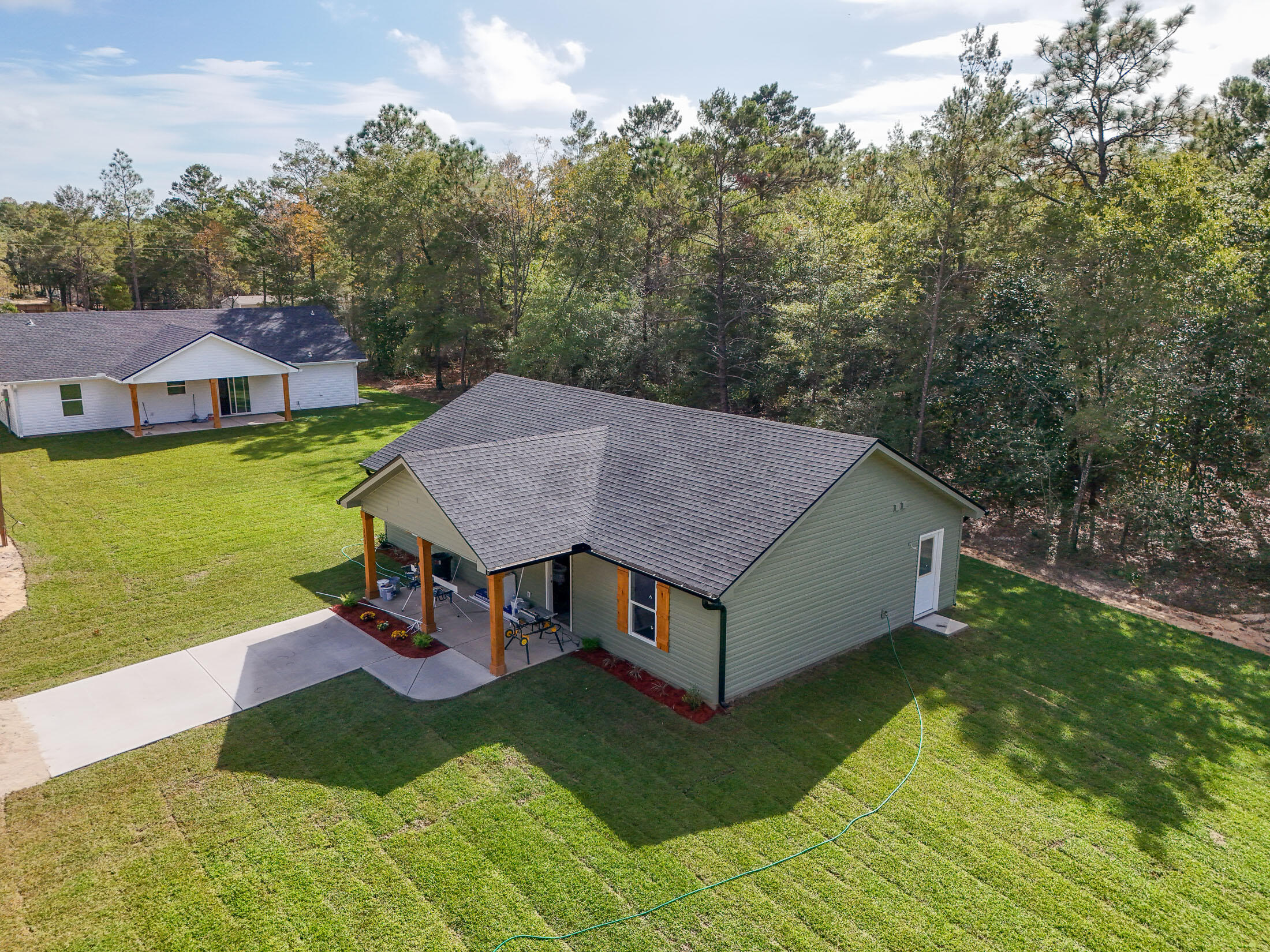 Welcome to your brand-new home, crafted by Darby Homes, and situated on nearly a quarter-acre just outside of town! This stunning property offers incredible curb appeal with a covered front porch featuring cedar-wrapped posts and a cedar-clad ceiling. Step inside to discover an open concept design with a vaulted ceiling and durable Luxury Vinyl Plank flooring throughout. The kitchen showcases quartz countertops, soft-closing cabinets, a stainless farmhouse sink, and sleek stainless appliances. The primary bedroom is a retreat with a walk-in closet and a luxurious ensuite bathroom, complete with beautiful tile flooring, a double vanity with quartz countertops, and a custom-tiled shower. 2 additional guest bedrooms with spacious closets complete this thoughtfully designed home.